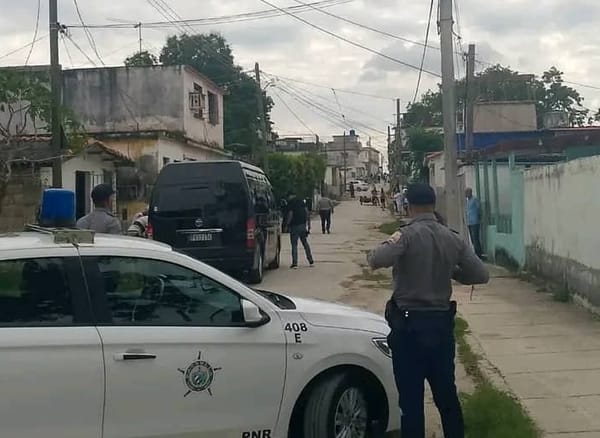 Policía patrullando calle con vehículos oficiales