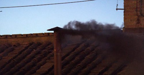 Chimenea emitiendo humo negro en un tejado